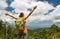 Woman traveler with backpack enjoying mountains view