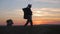 Woman traveler with backpack hiking in mountains. Silhouette hiker walking in the mountains, freedom and happiness