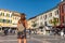 Woman traveler on beatiful Lake Garda in Sirmione, Lombardy, Italy. Scenic small town with traditional houses and clear blue water