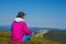 Woman traveler in bright colorful jacket meditate