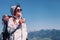 Woman traveler drinks tea on the mountain top