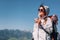 Woman traveler drinks tea on the mountain top