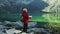 Woman traveler explorer with backpack hiking to the top of the mountain. Tourist hiker senior woman backpacker in
