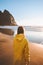 Woman traveler exploring Norway walking alone on Kvalvika beach