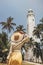 Woman Traveler in front of famous landmark of Sri Lanka country, Dondra lighthouse