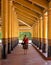 Woman traveler between gold columns of Royal Palace in Mandalay