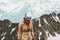 Woman traveler hiking in mountains with helmet gear