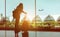 Woman traveler with luggage waiting airplane at airport