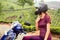 Woman traveler resting on motobike in tea plantations in india kerala munnar