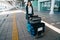 Woman traveler rolling luggage trolley outside