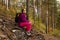 Woman traveler sat down to rest on a stone