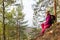 Woman traveler sat down to rest on a stone