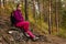 Woman traveler sat down to rest on a stone