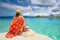 Woman traveler sit at the stern of boat at sunny day looking to