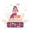 Woman traveler is sitting on baggage. Travel and route planning. Girl holding map in hands