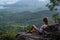 Woman traveler sitting on the cliff