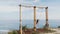 Woman traveler swinging on swing over cliff with beautiful view on ocean, slow motion