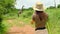 a woman traveler takes a photo of a giraffe in the jungle of the national park