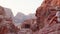 Woman traveler tourist sitting on viewpoint in Petra ancient city, ancient historical site famous travel destination of Jordan and