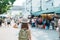 woman traveler visiting in Bangkok, Tourist with backpack and hat sightseeing in Chatuchak Weekend Market, landmark and popular