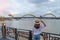 Woman Traveler visiting in Da Nang. Tourist sightseeing the river view with Dragon bridge at love lock bridge. Landmark and