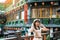 woman traveler visiting in Taiwan, Tourist with hat sightseeing in Jiufen Old Street village with Tea House background. landmark