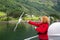 Woman traveling on ferry boat and feeding seagull