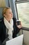 Woman traveling looking out the train window