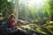 Woman traveller photographing ancient Mayan ruins.