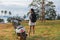 Woman traveller standing near motorcycle on the tropical beach.