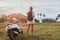 Woman traveller standing near motorcycle on the tropical beach.