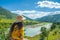 Woman traveller watching the spectacular view of blue mountains and Tsang river from the suspension bridge in Bhutan