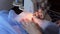 Woman treated tissue using overlock. Women\'s hands. Quickly sew close-up.