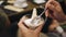 A woman is treated to a delicious dessert and a transparent cup