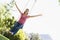 Woman on tree swing smiling