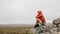 Woman trekker sitting on a hill