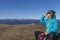 Woman trekker sunbathing in mountains