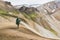 Woman trekking in the colourful mountains of Landmannalaugar national park, Iceland
