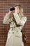 Woman in a trenchcoat with binoculars