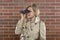 Woman in a trenchcoat with binoculars