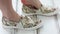 A woman tries on a new pair of slip-ons in the store. Legs close up. Shopping concept