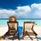 Woman on a tropical beach in chaise lounge