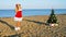 Woman on a tropical beach with a Christmas tree