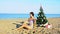 Woman on a tropical beach with a Christmas tree