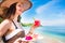 Woman at tropical beach eating fruit for breakfast