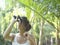 Woman In Tropical Forest Looking Through Binoculars