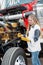 Woman truck driver checking the oil level on a big truck