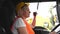 Woman truck driver talking by radio inside the cabin. Female trucker job worker