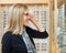 Woman Trying On Glasses In Optician Store