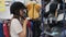 Woman trying on horse riding helmet in sports store